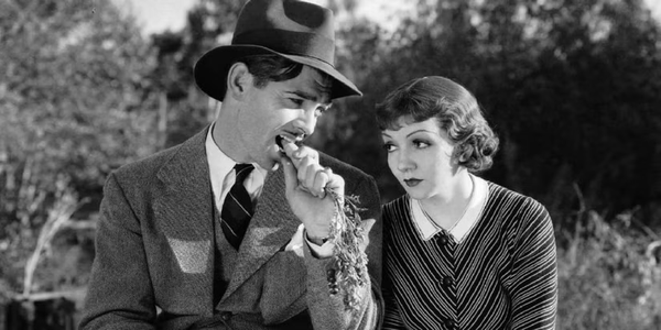 A frame of It Happened One Night, a famous 1934 movie featuring Clark Gable, seen hear munching on a carrot.